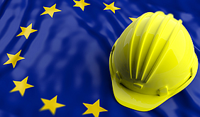 Gelber Helm auf europäischer Flagge.