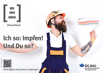 Ein junger Handwerker mit Helm singt und benutzt seine Malerrolle als Mikrofon.