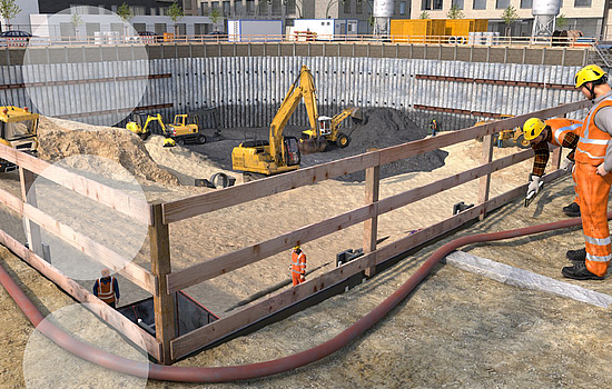 Mehrere Baumaschinen fertigen das Fundament eines Gebäudes.